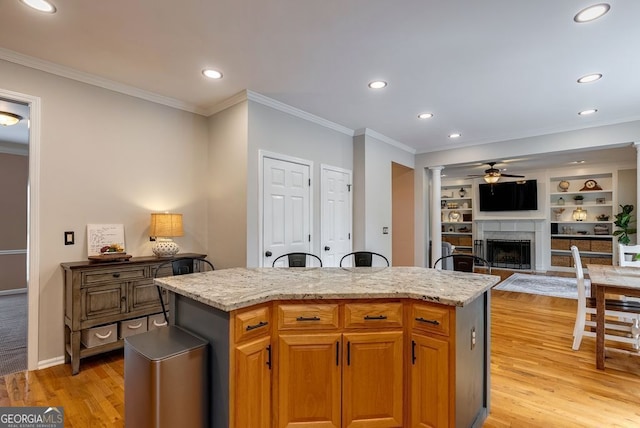 405 Woodbrook Way, Lawrenceville, GA 30043 - kitchen with a fireplace, ceiling fan, recessed lighting, light wood finished floors, and ornamental molding