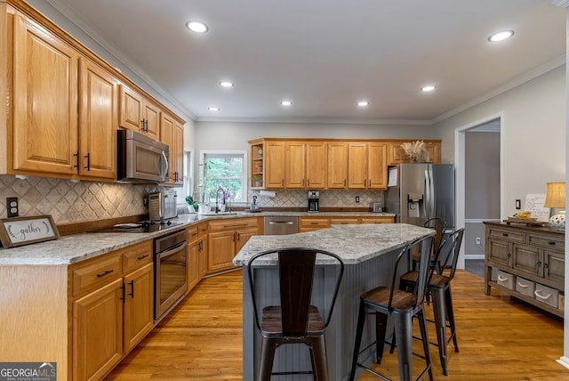 405 Woodbrook Way, Lawrenceville, GA 30043 - kitchen featuring appliances with stainless steel finishes, ornamental molding, a breakfast bar, recessed lighting, and light stone countertops
