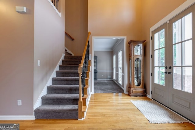 405 Woodbrook Way, Lawrenceville, GA 30043 - foyer featuring stairs, plenty of natural light, wood finished floors, french doors, and crown molding