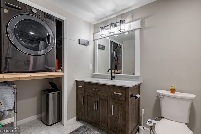 405 Woodbrook Way, Lawrenceville, GA 30043 - bathroom with vanity, estacked washer and dryer, toilet, and baseboards
