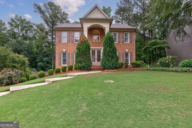 405 Woodbrook Way, Lawrenceville, GA 30043 - view of front of property with french doors, brick siding, and a front lawn