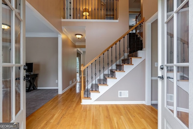 405 Woodbrook Way, Lawrenceville, GA 30043 - foyer entrance featuring ornamental molding, french doors, wood finished floors, stairway, and baseboards