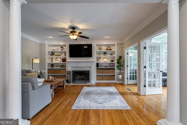 405 Woodbrook Way, Lawrenceville, GA 30043 - living area with ornate columns, ornamental molding, ceiling fan, a fireplace with flush hearth, and light wood-style floors