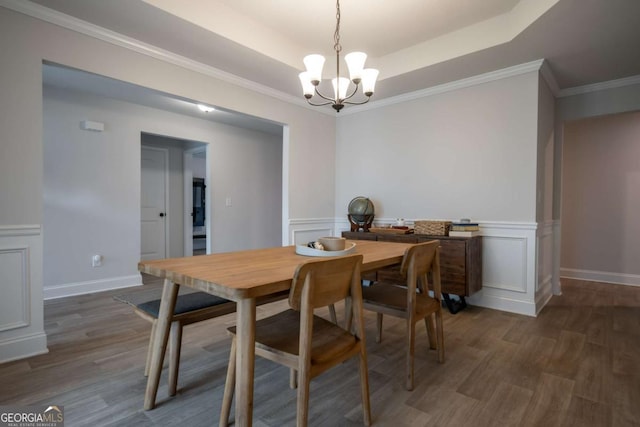 35 Westwood St, Danielsville, GA 30633 - dining room featuring a chandelier, wood finished floors, a decorative wall, a raised ceiling, and a wainscoted wall