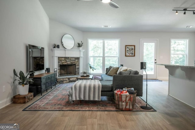 35 Westwood St, Danielsville, GA 30633 - living area with wood finished floors, baseboards, ceiling fan, and a fireplace
