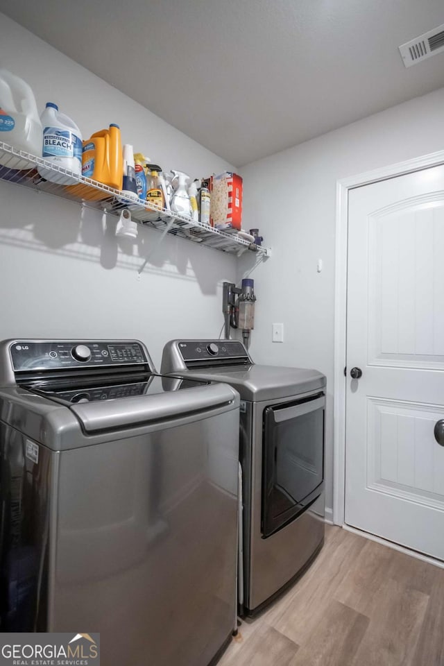 35 Westwood St, Danielsville, GA 30633 - laundry area with washer and dryer and light wood-style floors