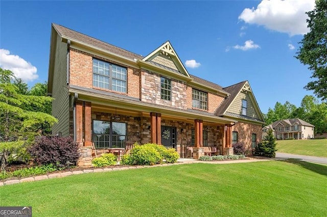 501 Rabun Ct, Canton, GA 30115 - view of front of house with a porch, stone siding, and a front lawn