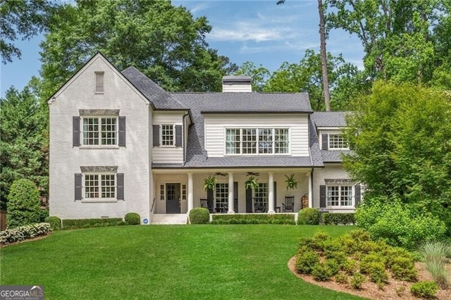 3894 Land O Lakes Dr NE, Atlanta, GA 30342 - rear view of house featuring ceiling fan, a lawn, a chimney, and a shingled roof