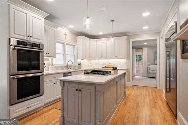 3894 Land O Lakes Dr NE, Atlanta, GA 30342 - kitchen featuring appliances with stainless steel finishes, light countertops, white cabinets, tasteful backsplash, and ornamental molding