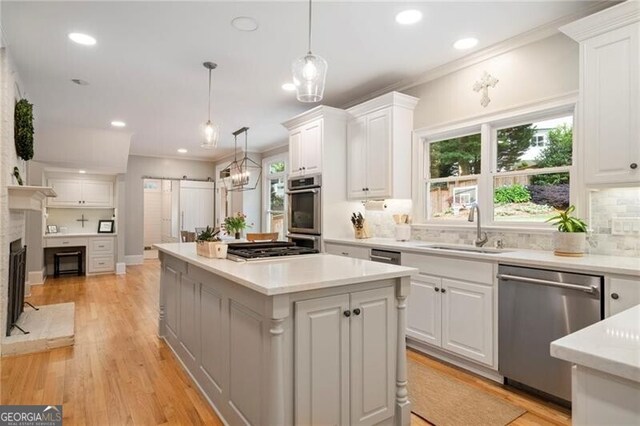 3894 Land O Lakes Dr NE, Atlanta, GA 30342 - kitchen with stainless steel appliances, ornamental molding, a center island, white cabinetry, and decorative backsplash