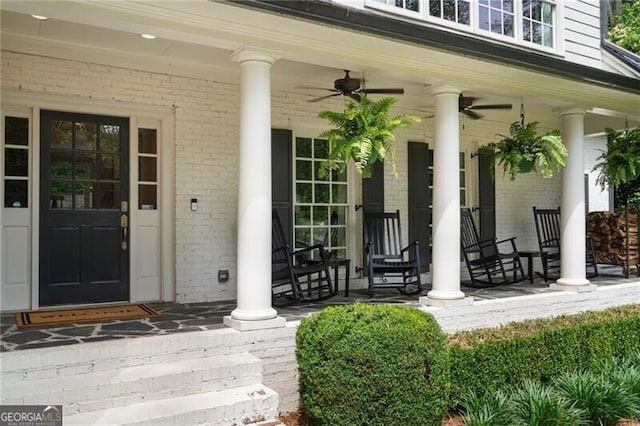 3894 Land O Lakes Dr NE, Atlanta, GA 30342 - view of exterior entry featuring a porch, brick siding, and a ceiling fan