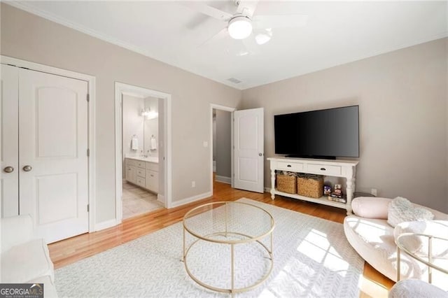 3894 Land O Lakes Dr NE, Atlanta, GA 30342 - living room with light wood finished floors, ceiling fan, and crown molding
