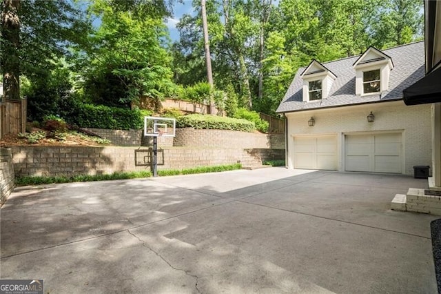 3894 Land O Lakes Dr NE, Atlanta, GA 30342 - garage with driveway and view of scattered trees