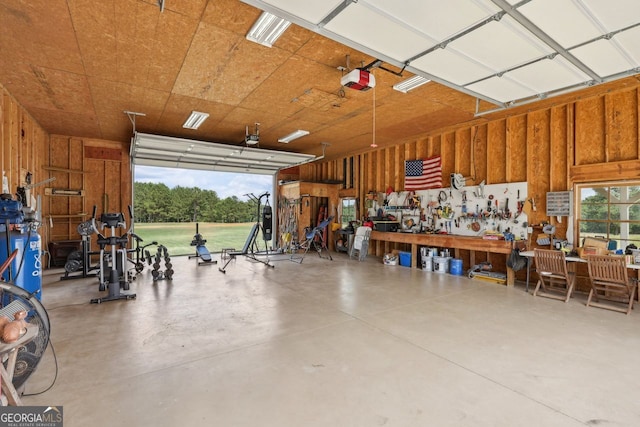 625 Henderson Mill Rd, Covington, GA 30014 - garage featuring a garage door opener and a workshop area