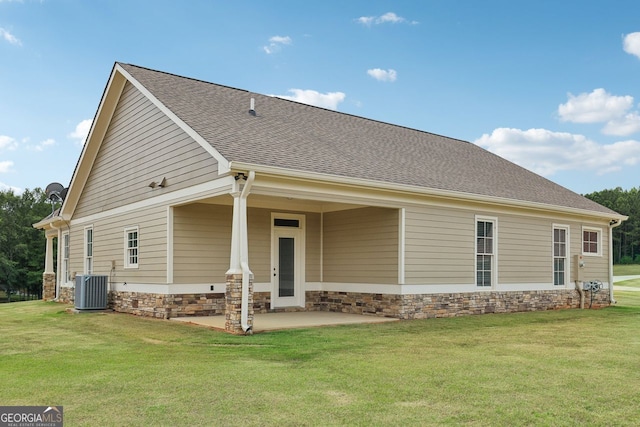 625 Henderson Mill Rd, Covington, GA 30014 - rear view of property featuring central AC, a lawn, stone siding, a patio area, and roof with shingles