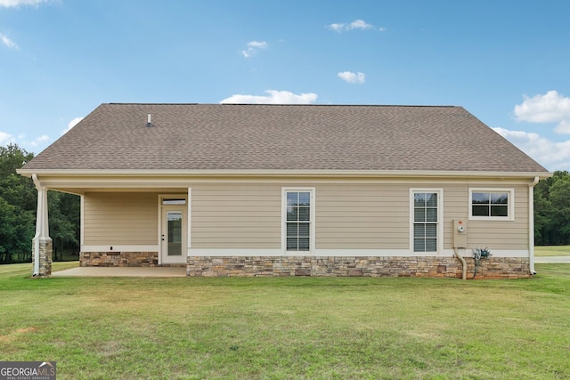 625 Henderson Mill Rd, Covington, GA 30014 - back of house with a lawn, a patio area, roof with shingles, and stone siding