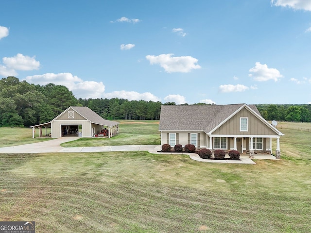 625 Henderson Mill Rd, Covington, GA 30014 - view of front facade with an outbuilding, a front yard, a porch, concrete driveway, and board and batten siding