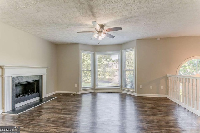 42 Breckenridge Dr, Powder Springs, GA 30127 - unfurnished living room featuring ceiling fan, wood finished floors, baseboards, a high end fireplace, and a textured ceiling