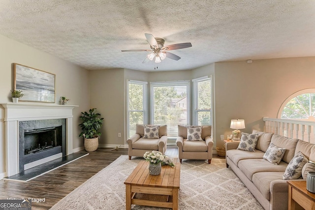 42 Breckenridge Dr, Powder Springs, GA 30127 - living room featuring ceiling fan, wood finished floors, baseboards, a textured ceiling, and a premium fireplace