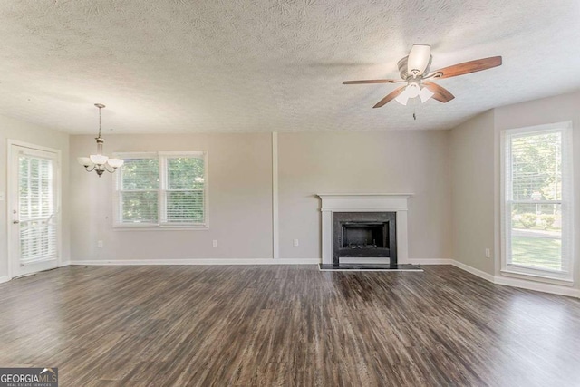42 Breckenridge Dr, Powder Springs, GA 30127 - unfurnished living room featuring dark wood finished floors, a textured ceiling, a chandelier, a fireplace, and baseboards