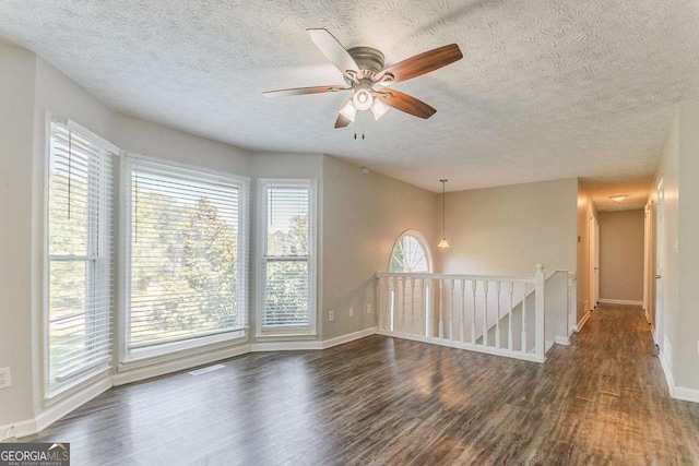 42 Breckenridge Dr, Powder Springs, GA 30127 - empty room featuring dark wood-type flooring, a textured ceiling, baseboards, and ceiling fan