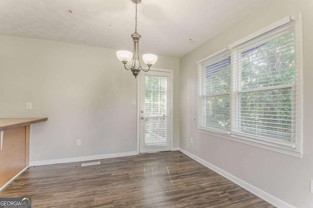42 Breckenridge Dr, Powder Springs, GA 30127 - unfurnished dining area with a chandelier, dark wood finished floors, and baseboards