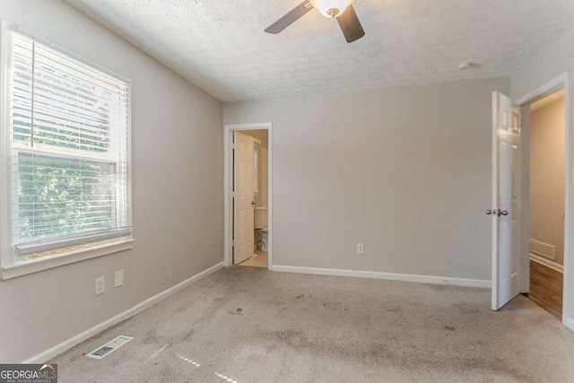 42 Breckenridge Dr, Powder Springs, GA 30127 - unfurnished bedroom featuring a textured ceiling, carpet flooring, baseboards, ceiling fan, and ensuite bathroom