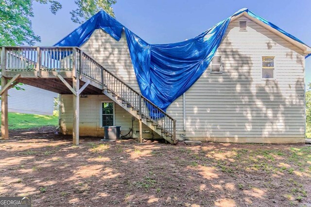42 Breckenridge Dr, Powder Springs, GA 30127 - back of property featuring stairs, a wooden deck, and central air condition unit