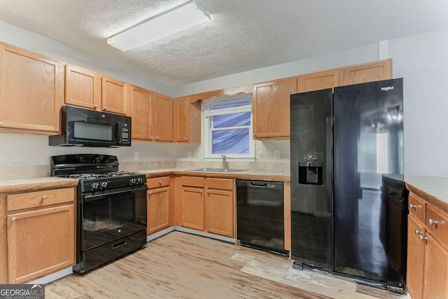 42 Breckenridge Dr, Powder Springs, GA 30127 - kitchen featuring black appliances, a sink, light countertops, and a textured ceiling