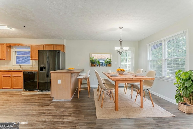 42 Breckenridge Dr, Powder Springs, GA 30127 - dining area with dark wood finished floors, a chandelier, baseboards, and a textured ceiling