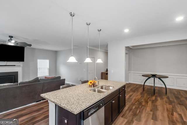 1243 Polk Xing, Mcdonough, GA 30252 - kitchen with stainless steel dishwasher, a fireplace, dark wood-style flooring, pendant lighting, and light stone countertops
