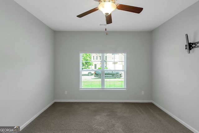 1243 Polk Xing, Mcdonough, GA 30252 - empty room with dark carpet and a ceiling fan