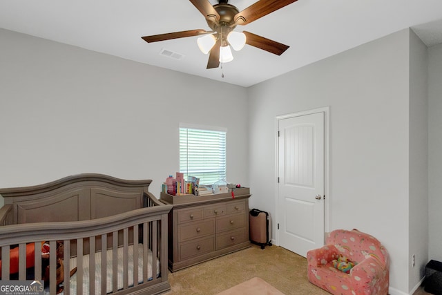1243 Polk Xing, Mcdonough, GA 30252 - bedroom with light carpet, a nursery area, and a ceiling fan