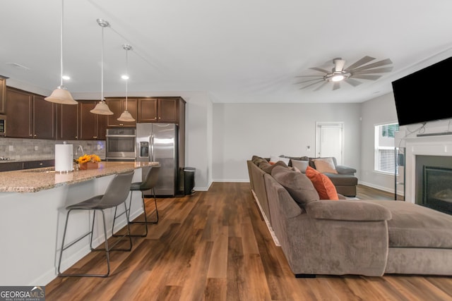 1243 Polk Xing, Mcdonough, GA 30252 - living area with ceiling fan, dark wood finished floors, a fireplace, and recessed lighting