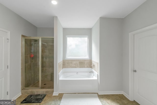 1243 Polk Xing, Mcdonough, GA 30252 - bathroom with a bath, a shower stall, and tile patterned floors