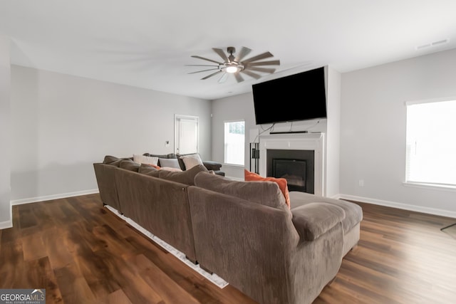 1243 Polk Xing, Mcdonough, GA 30252 - living room with ceiling fan, dark wood-type flooring, and a glass covered fireplace