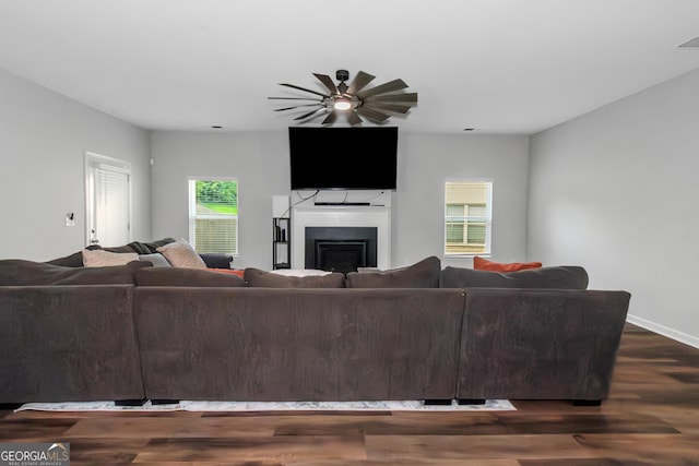 1243 Polk Xing, Mcdonough, GA 30252 - living area with dark wood-style floors, a fireplace, and ceiling fan