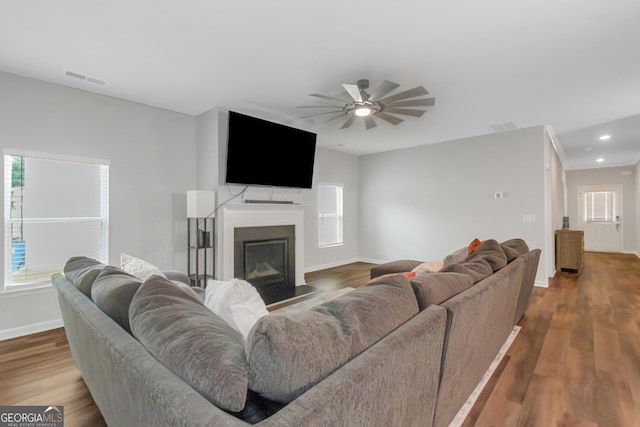 1243 Polk Xing, Mcdonough, GA 30252 - living area with ceiling fan, wood finished floors, a fireplace with flush hearth, and recessed lighting