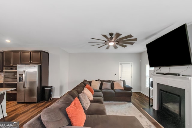 1243 Polk Xing, Mcdonough, GA 30252 - living room with wood finished floors, a ceiling fan, a fireplace, and recessed lighting