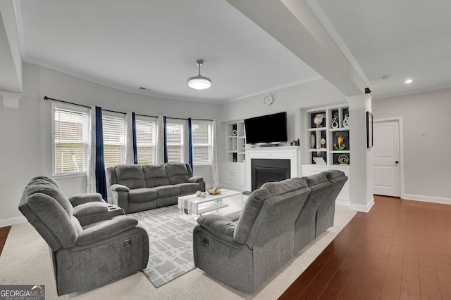 2740 Longacre Park Way, Lawrenceville, GA 30044 - living room with decorative columns, a fireplace, baseboards, crown molding, and dark wood-style flooring