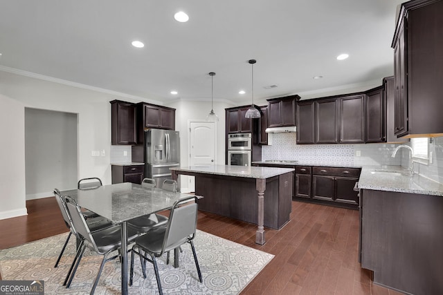 2740 Longacre Park Way, Lawrenceville, GA 30044 - kitchen with a sink, a kitchen island, ornamental molding, stainless steel appliances, and dark brown cabinets