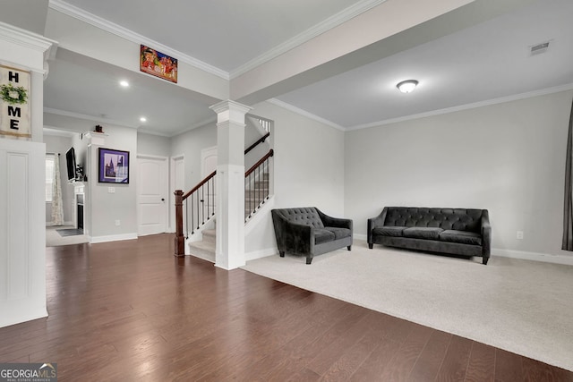 2740 Longacre Park Way, Lawrenceville, GA 30044 - living area featuring stairs, baseboards, wood finished floors, decorative columns, and crown molding