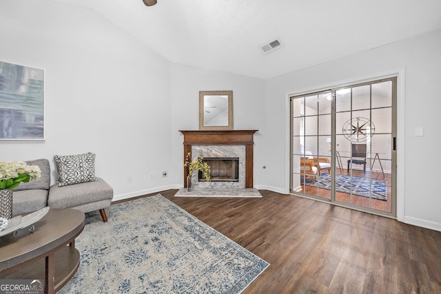 4941 Lighthouse Pointe, Acworth, GA 30101 - living room featuring wood finished floors, vaulted ceiling, baseboards, and a premium fireplace