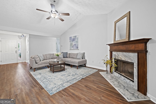 4941 Lighthouse Pointe, Acworth, GA 30101 - living area featuring a textured ceiling, baseboards, dark wood finished floors, a ceiling fan, and a premium fireplace