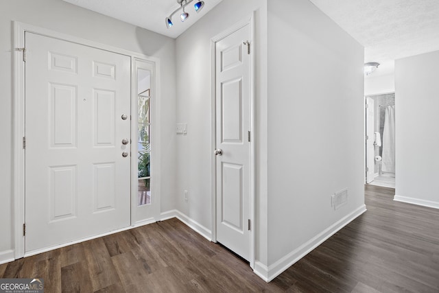 4941 Lighthouse Pointe, Acworth, GA 30101 - entryway featuring dark wood-style flooring, baseboards, and a textured ceiling
