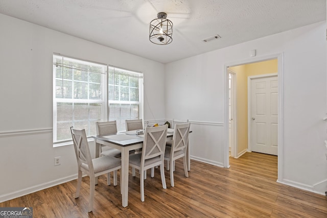 1450 Steam Engine Way NE, Conyers, GA 30013 - dining area featuring wood finished floors and a textured ceiling