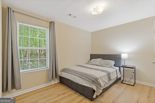1450 Steam Engine Way NE, Conyers, GA 30013 - bedroom featuring wood finished floors and multiple windows