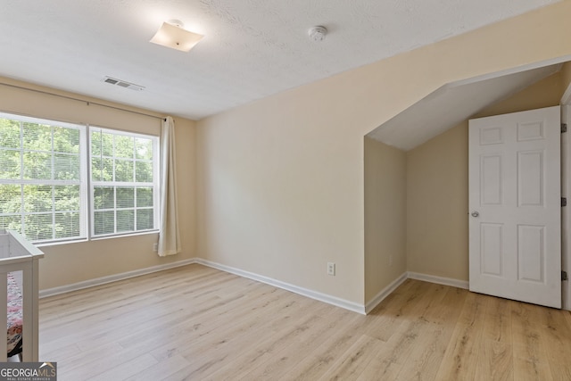 1450 Steam Engine Way NE, Conyers, GA 30013 - unfurnished bedroom with light wood-style flooring and vaulted ceiling