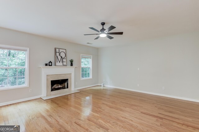 2725 Sedgeview Way, Buford, GA 30519 - unfurnished living room with light wood finished floors, a high end fireplace, and ceiling fan