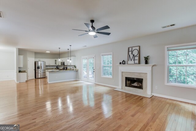 2725 Sedgeview Way, Buford, GA 30519 - unfurnished living room featuring ceiling fan, light wood finished floors, and a high end fireplace